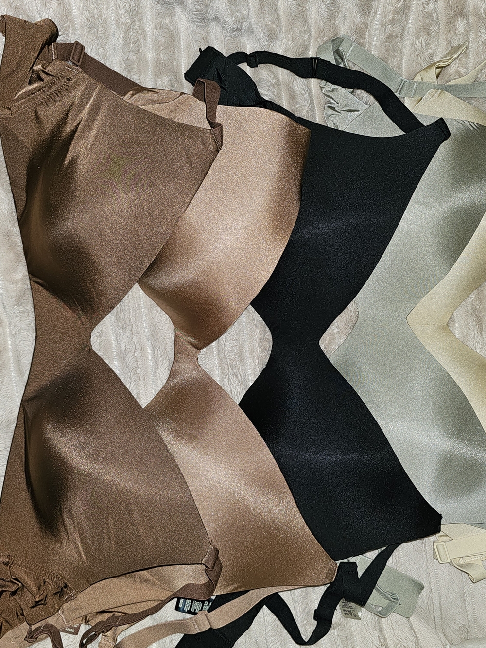 SKIMS Seamless Smooth Bras in Sage, Light-Dark Brown, Black & Cream